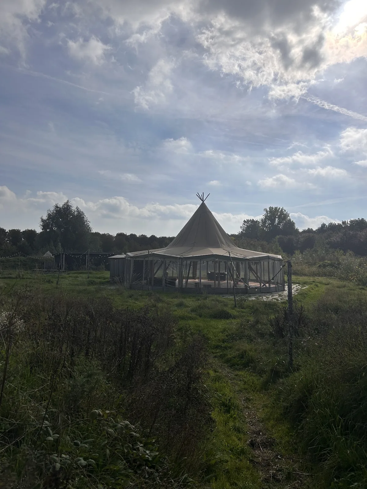 De tent tussen de bomen en velden